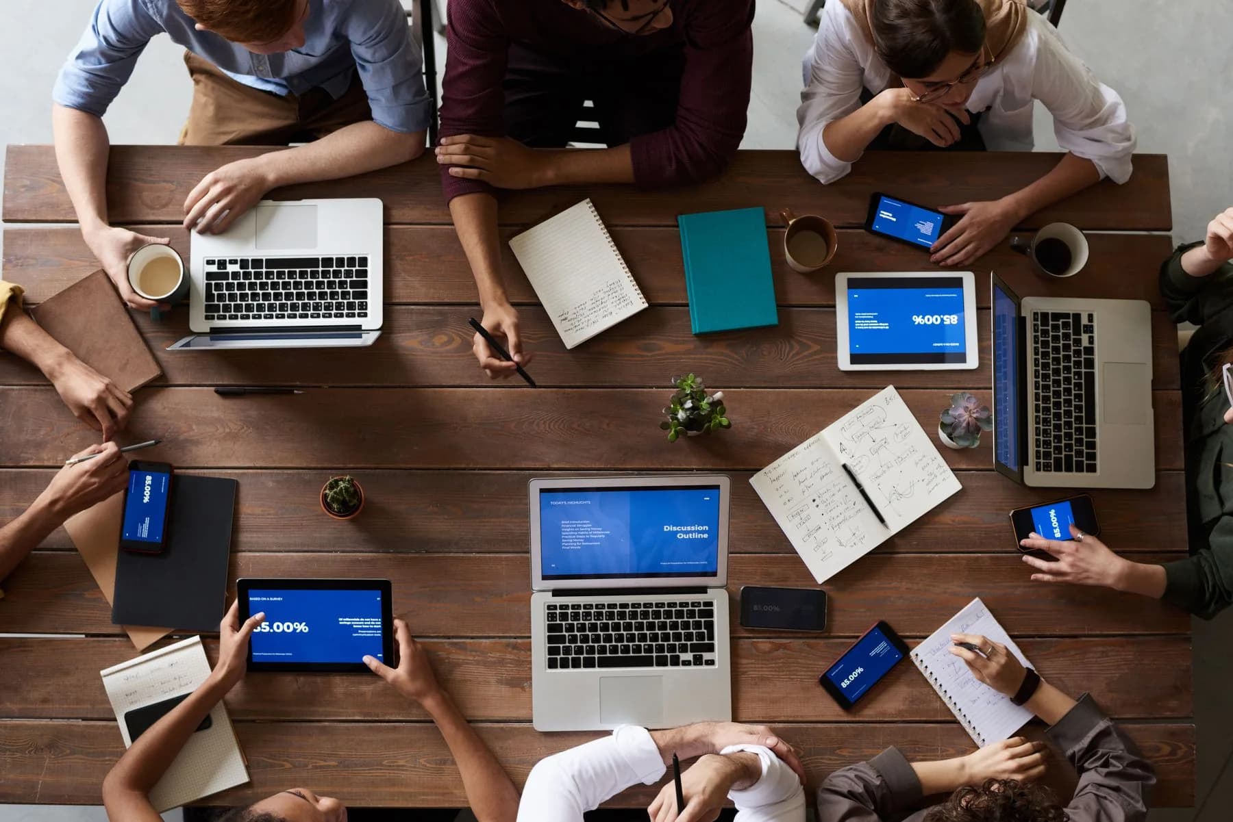 People working together with documents and computers.