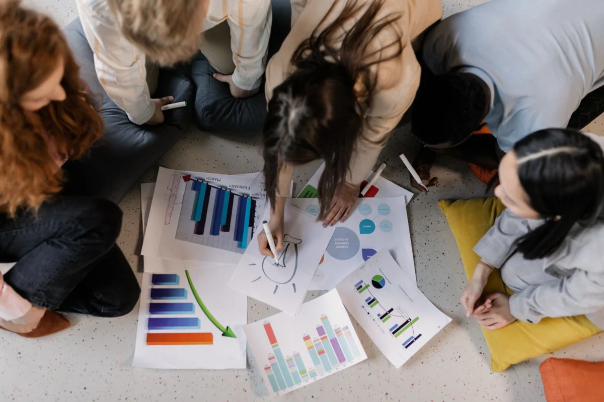 A team reviews process diagrams and charts together during a working session.