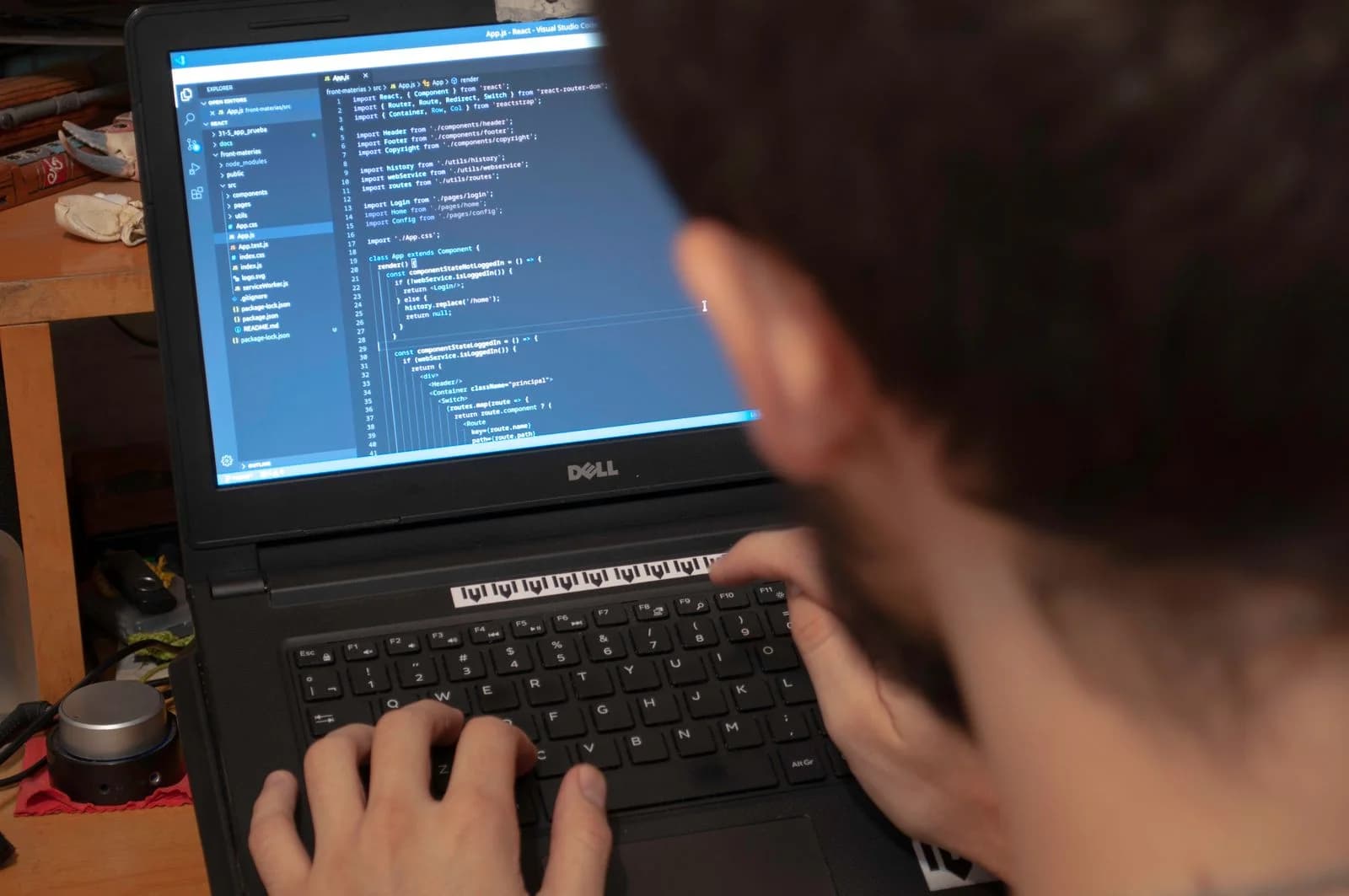 A developer writing application code on a laptop.