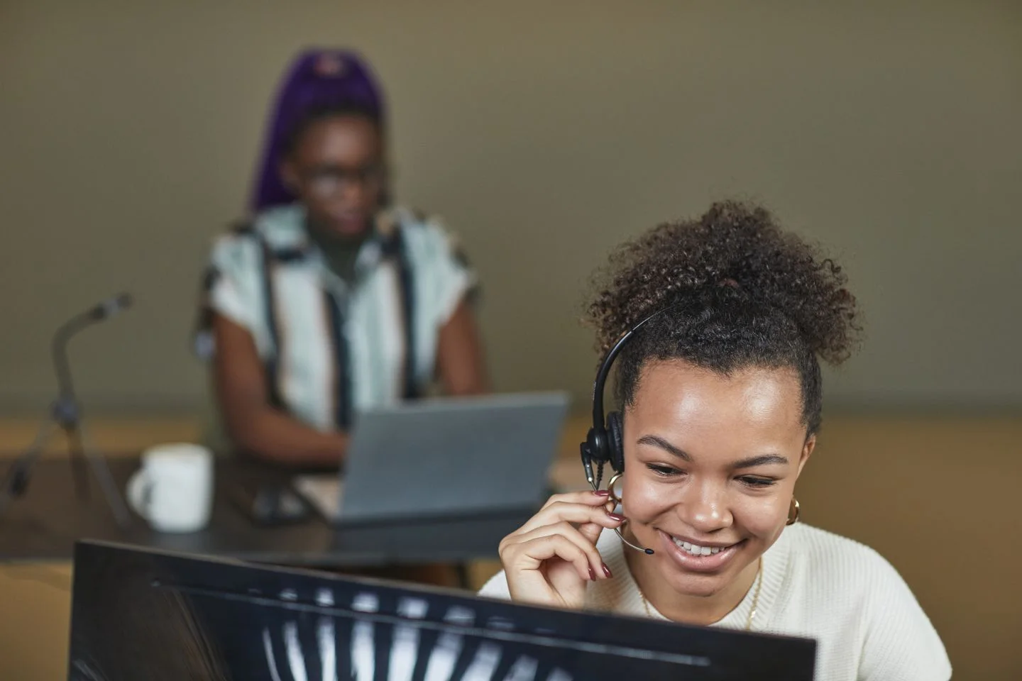 A professional wearing a headset during a remote conversation.